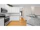 Modern kitchen with granite countertops, stainless steel appliances, and white cabinetry at 5578 Hedge Brooke Dr, Acworth, GA 30101