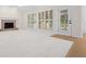 Spacious living room with a fireplace, ample natural light, and neutral carpet flooring at 5578 Hedge Brooke Dr, Acworth, GA 30101