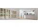 Open concept living room connected to kitchen, featuring white cabinetry and a breakfast bar at 5578 Hedge Brooke Dr, Acworth, GA 30101