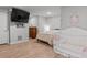 Finished basement bedroom with TV, crib and queen bed at 5135 Arnold St, Covington, GA 30014