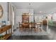 Bright dining room with hardwood floors, a wooden table set for six, and an elegant chandelier at 5135 Arnold St, Covington, GA 30014