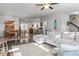 Open-concept living area with a large sectional, hardwood floors, and views of dining and kitchen areas at 5135 Arnold St, Covington, GA 30014