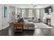 Stylish living room with dark wood floors, gray sectional, fireplace, and large windows for natural light at 5135 Arnold St, Covington, GA 30014