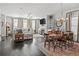 Open-concept living room with combined dining room showcasing hardwood floors and abundant natural light at 5135 Arnold St, Covington, GA 30014