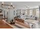 Spacious living room flows into the dining area, featuring a large sectional, fireplace, and dark hardwood floors at 5135 Arnold St, Covington, GA 30014