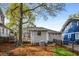 The backyard features a deck, mature trees and a privacy fence with a small grassy area at 73 Waddell Ne St, Atlanta, GA 30307