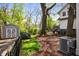 A fenced backyard with a storage shed, lawn, mulch and shade trees creates a private outdoor space at 73 Waddell Ne St, Atlanta, GA 30307