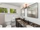 Bathroom featuring a double vanity with granite countertop, mirrors, and plenty of natural light from two large windows at 73 Waddell Ne St, Atlanta, GA 30307