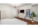 Bright bedroom featuring hardwood floors, white walls, chandelier, and large windows for ample natural light at 73 Waddell Ne St, Atlanta, GA 30307