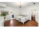 Bedroom featuring hardwood floors, white walls, chandelier, and ensuite bathroom at 73 Waddell Ne St, Atlanta, GA 30307