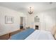 Bedroom featuring carpet, white walls, fireplace, and chandelier at 73 Waddell Ne St, Atlanta, GA 30307