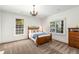 Bright bedroom featuring carpet, white walls, chandelier, and two large windows at 73 Waddell Ne St, Atlanta, GA 30307