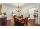 Inviting dining room with hardwood floors, chandelier, and access to the kitchen at 73 Waddell Ne St, Atlanta, GA 30307