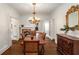 Elegant dining room with hardwood floors, chandelier, and adjacent fireplace at 73 Waddell Ne St, Atlanta, GA 30307