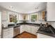 Bright kitchen featuring stainless steel appliances, dark countertops, and hardwood floors at 73 Waddell Ne St, Atlanta, GA 30307