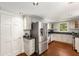 Bright kitchen featuring stainless steel appliances, dark countertops, and hardwood floors at 73 Waddell Ne St, Atlanta, GA 30307