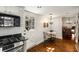 Eat-in kitchen featuring stainless steel appliances, dark countertops, and hardwood floors at 73 Waddell Ne St, Atlanta, GA 30307