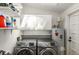 Laundry room with white cabinets and shelves, featuring washer and dryer at 73 Waddell Ne St, Atlanta, GA 30307