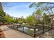 Exterior of a fenced pond surrounded by trees and greenery, complemented by walkways and benches at 73 Waddell Ne St, Atlanta, GA 30307