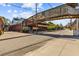 Street view featuring a pedestrian bridge and businesses with outdoor seating under a partly cloudy blue sky at 73 Waddell Ne St, Atlanta, GA 30307