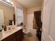 Well-lit bathroom featuring a shower-tub combo, vanity with sink and decorative accents at 828 Cooper Lakes Ct, Grayson, GA 30017