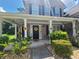 Charming brick home featuring a welcoming front porch adorned with sunflower decorations and lush landscaping at 828 Cooper Lakes Ct, Grayson, GA 30017