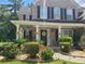 Beautiful two-story brick home with black shutters, a covered front porch, and well-maintained landscaping at 828 Cooper Lakes Ct, Grayson, GA 30017
