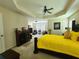 Spacious main bedroom boasts ceiling fan, sitting area, and cozy fireplace at 828 Cooper Lakes Ct, Grayson, GA 30017