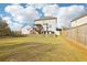 Wide backyard view showing a wooden fence, sloped yard and home exterior with a deck at 139 Rushing View Gln, Dallas, GA 30157