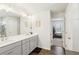Bright bathroom with double sink vanity, framed mirror, modern lighting, and wood-look flooring at 139 Rushing View Gln, Dallas, GA 30157