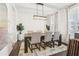 Dining room featuring modern lighting, a dining table with seating for six, and natural light from the window at 139 Rushing View Gln, Dallas, GA 30157