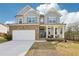 Charming two-story home featuring stone accents, inviting front porch, and a well-maintained front yard at 139 Rushing View Gln, Dallas, GA 30157