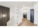 Upstairs hallway featuring black accent wall, laundry room access and a linen closet at 139 Rushing View Gln, Dallas, GA 30157