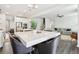 Open-concept kitchen with a central island, breakfast bar, and seamless flow into the adjacent living space at 139 Rushing View Gln, Dallas, GA 30157