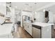 Bright kitchen features stainless appliances, quartz countertops, kitchen island and pendant lighting at 139 Rushing View Gln, Dallas, GA 30157