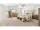 Main bedroom with neutral carpet, ceiling fan, decorative mirror, and dresser at 139 Rushing View Gln, Dallas, GA 30157