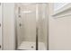 Bathroom with walk-in shower, neutral tile surround, and sliding glass door at 139 Rushing View Gln, Dallas, GA 30157