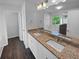 Modern bathroom with granite counters, dual sinks, and a separate tub and shower at 280 Mcgiboney Ln, Covington, GA 30016