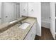 Bright bathroom with granite countertop, white cabinets, and a full sized mirror at 280 Mcgiboney Ln, Covington, GA 30016
