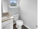 Cozy half bathroom with granite countertop and a white toilet at 280 Mcgiboney Ln, Covington, GA 30016