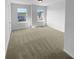 A bright bedroom with neutral carpet and natural light from two windows at 280 Mcgiboney Ln, Covington, GA 30016