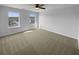 Spacious bedroom with neutral carpet, two windows, and overhead lighting at 280 Mcgiboney Ln, Covington, GA 30016