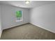 Comfortable bedroom featuring plush carpeting and a window with backyard view at 280 Mcgiboney Ln, Covington, GA 30016