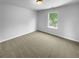 Neutral bedroom with hardwood floors, natural light from a large window and ample space at 280 Mcgiboney Ln, Covington, GA 30016
