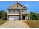 Charming two-story home featuring neutral siding, a two-car garage, and a well-manicured front yard at 280 Mcgiboney Ln, Covington, GA 30016