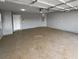 Spacious and well-lit two car garage with concrete flooring and an automatic door opener at 280 Mcgiboney Ln, Covington, GA 30016
