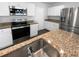Modern kitchen with granite countertops, stainless steel appliances, and a stainless steel sink at 280 Mcgiboney Ln, Covington, GA 30016