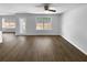 Spacious living room with ceiling fan, hardwood floors, large windows, and backyard views at 280 Mcgiboney Ln, Covington, GA 30016