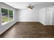 Sunlit living room with stylish wood flooring, a ceiling fan, and large windows at 280 Mcgiboney Ln, Covington, GA 30016