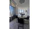 Bright, open dining area with city views through floor to ceiling windows and glass sliding door to a balcony at 285 Centennial Olympic Park Dr # Ph 1-4, Atlanta, GA 30313